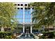 Modern building with beautiful glass facade surrounded by trees and plants at 3324 Peachtree Ne Rd # 2807, Atlanta, GA 30326