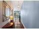 Hallway with hardwood floors, decorative mirror, light fixtures, and view into the living room at 3324 Peachtree Ne Rd # 2807, Atlanta, GA 30326