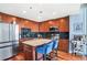 Modern kitchen features stainless steel appliances, dark backsplash, central island with breakfast bar, and wood floors at 3324 Peachtree Ne Rd # 2807, Atlanta, GA 30326