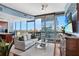 Bright living room features large windows with amazing city views and comfortable seating arrangement at 3324 Peachtree Ne Rd # 2807, Atlanta, GA 30326