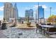 Outdoor pool area with barbecue grill and dining area, ideal for gatherings with urban views in the background at 3324 Peachtree Ne Rd # 2807, Atlanta, GA 30326