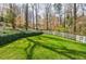 Large backyard with green grass and a white fence, perfect for outdoor activities at 3790 Narmore Ne Dr, Atlanta, GA 30319