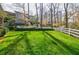 Large backyard with green grass and a white fence, perfect for outdoor activities at 3790 Narmore Ne Dr, Atlanta, GA 30319