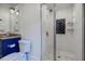 Stylish bathroom features blue vanity, marble floors in glass shower with white subway tile at 3790 Narmore Ne Dr, Atlanta, GA 30319
