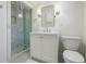 Modern bathroom featuring glass shower, white vanity, and ceramic tiled floors at 3790 Narmore Ne Dr, Atlanta, GA 30319