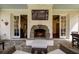 Outdoor fireplace under a large mounted TV is centrally located in the outdoor covered patio at 3790 Narmore Ne Dr, Atlanta, GA 30319