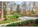 Driveway leading to a home surrounded by mature trees and lush greenery, offering privacy and a serene setting at 3790 Narmore Ne Dr, Atlanta, GA 30319