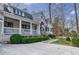Exterior view of a home with a welcoming front porch, white pillars, and a beautifully landscaped yard and walkway at 3790 Narmore Ne Dr, Atlanta, GA 30319