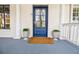 Inviting front entrance featuring a blue door, decorative plants, and white columns, offering great curb appeal at 3790 Narmore Ne Dr, Atlanta, GA 30319
