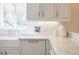 Detailed kitchen view with white subway tile backsplash, farmhouse sink, marble countertops, and ample natural light at 3790 Narmore Ne Dr, Atlanta, GA 30319