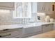 Kitchen sink and counter detail featuring white cabinetry, subway tile backsplash, elegant faucet and marble countertops at 3790 Narmore Ne Dr, Atlanta, GA 30319