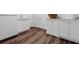 Bright laundry room featuring modern white cabinetry, sink, and durable wood flooring at 3790 Narmore Ne Dr, Atlanta, GA 30319