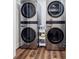 Modern silver stackable laundry machines are featured in the laundry area of the home at 3790 Narmore Ne Dr, Atlanta, GA 30319