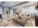 Cozy living room with exposed beams, a plush sofa, and an open layout connected to the kitchen at 3790 Narmore Ne Dr, Atlanta, GA 30319