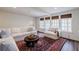 Inviting living room with neutral decor, built-ins, and three large windows at 3790 Narmore Ne Dr, Atlanta, GA 30319