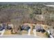 Aerial view of a home with mature trees, a well-manicured lawn, and a nearby pool at 4296 Alba Ln, Buford, GA 30519