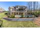 Beautifully landscaped backyard with a stone retaining wall, a pool, and wrought iron fence at 4296 Alba Ln, Buford, GA 30519
