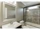 Bathroom featuring a shower and tub combo with decorative tile and a large framed mirror at 4296 Alba Ln, Buford, GA 30519