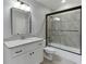 Bathroom features a shower, bathtub, grey tile, white cabinetry, and granite countertop at 4296 Alba Ln, Buford, GA 30519