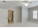 Neutral bedroom view into bathroom featuring white door, carpet and light walls at 4296 Alba Ln, Buford, GA 30519