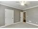 Neutral bedroom with a view into a stairwell, offering a calm and inviting atmosphere at 4296 Alba Ln, Buford, GA 30519
