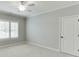 Neutral carpeted bedroom with white door and window with shutter style blinds at 4296 Alba Ln, Buford, GA 30519