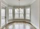 Breakfast nook featuring three windows with natural light and hardwood floors at 4296 Alba Ln, Buford, GA 30519