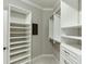 A modern walk-in closet featuring built-in shelving and drawers with carpeted flooring at 4296 Alba Ln, Buford, GA 30519
