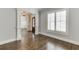 Light-filled room with hardwood floors, plantation shutters, and white trim at 4296 Alba Ln, Buford, GA 30519