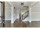 Grand foyer with hardwood floors, white trim, and an open staircase at 4296 Alba Ln, Buford, GA 30519