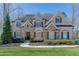 Charming brick home with stone accents, manicured lawn, and mature trees at 4296 Alba Ln, Buford, GA 30519