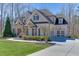 Elegant residence with a brick and stone facade, complemented by a paved driveway at 4296 Alba Ln, Buford, GA 30519