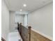 A bright hallway boasts wood floors, decorative railings, and neutral walls at 4296 Alba Ln, Buford, GA 30519