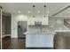 This updated kitchen features an island, stainless steel appliances, granite counters, and white cabinetry at 4296 Alba Ln, Buford, GA 30519