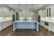 This is a spacious kitchen that features white cabinets, stainless steel appliances, and a large center island at 4296 Alba Ln, Buford, GA 30519