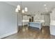 Open kitchen and dining area with stainless appliances, hardwood floors and large island at 4296 Alba Ln, Buford, GA 30519