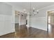 Spacious living room with hardwood floors, decorative columns, and ample natural light at 4296 Alba Ln, Buford, GA 30519