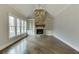 A bright living room showcases a stone fireplace, built-in bookshelves, and large windows with natural light at 4296 Alba Ln, Buford, GA 30519