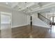 Open living room with hardwood floors, coffered ceiling and stairs at 4296 Alba Ln, Buford, GA 30519