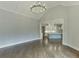 An open living room with hardwood floors and a kitchen view features oversized windows that provide natural light at 4296 Alba Ln, Buford, GA 30519