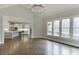 The open living room features hardwood floors, a view of the kitchen, and oversized windows providing ample natural light at 4296 Alba Ln, Buford, GA 30519