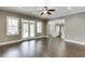 Spacious living room features hardwood floors, neutral paint, and ample natural light from multiple windows and french doors at 4296 Alba Ln, Buford, GA 30519