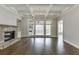Bright living room featuring a stone fireplace, coffered ceiling, and hardwood floors at 4296 Alba Ln, Buford, GA 30519