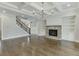 Living room features a stone fireplace, built-in shelves and hardwood flooring at 4296 Alba Ln, Buford, GA 30519