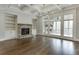 Open-concept living room with coffered ceiling, fireplace, and built-in shelves at 4296 Alba Ln, Buford, GA 30519