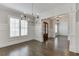 Bright living room featuring a modern chandelier, hardwood floors, and white trim at 4296 Alba Ln, Buford, GA 30519
