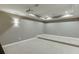 This media room features a projector, tray ceiling, recessed lighting, sconces, and theater-style seating at 4296 Alba Ln, Buford, GA 30519
