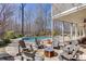 Outdoor seating area with a fire pit next to the pool, creating an inviting gathering space at 4296 Alba Ln, Buford, GA 30519