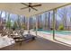 Relaxing covered patio with lounge chairs overlooking the lush backyard and pool at 4296 Alba Ln, Buford, GA 30519