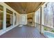 Spacious covered patio with stone fireplace and ceiling fan, ideal for outdoor entertaining at 4296 Alba Ln, Buford, GA 30519